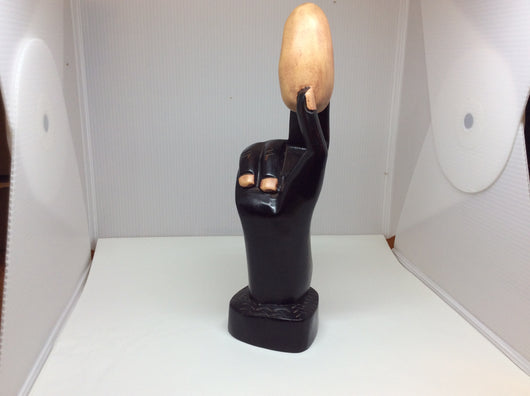 Hand Holding an Egg Carving